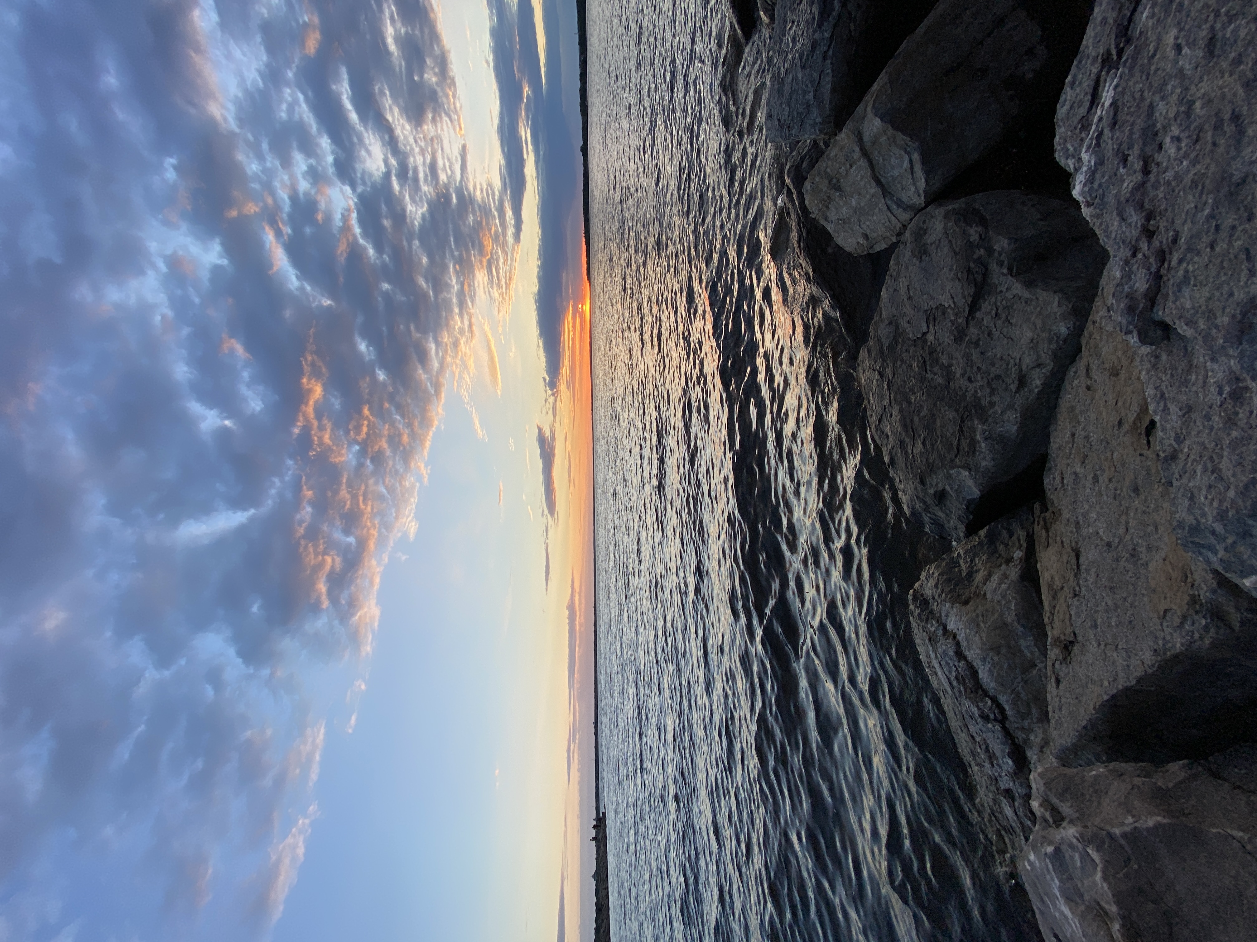 A view of a lake, standing on a rocky ledge