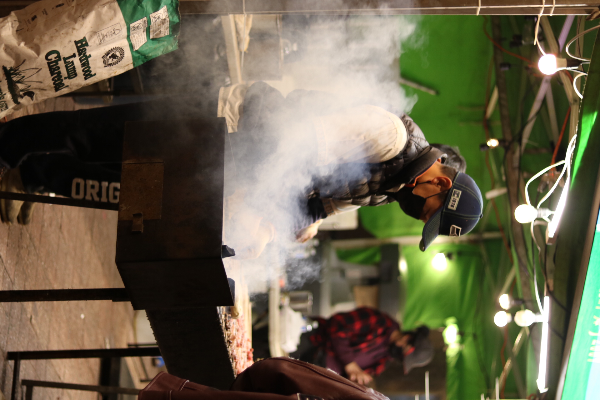 a man preparing fried squid at an asian night market