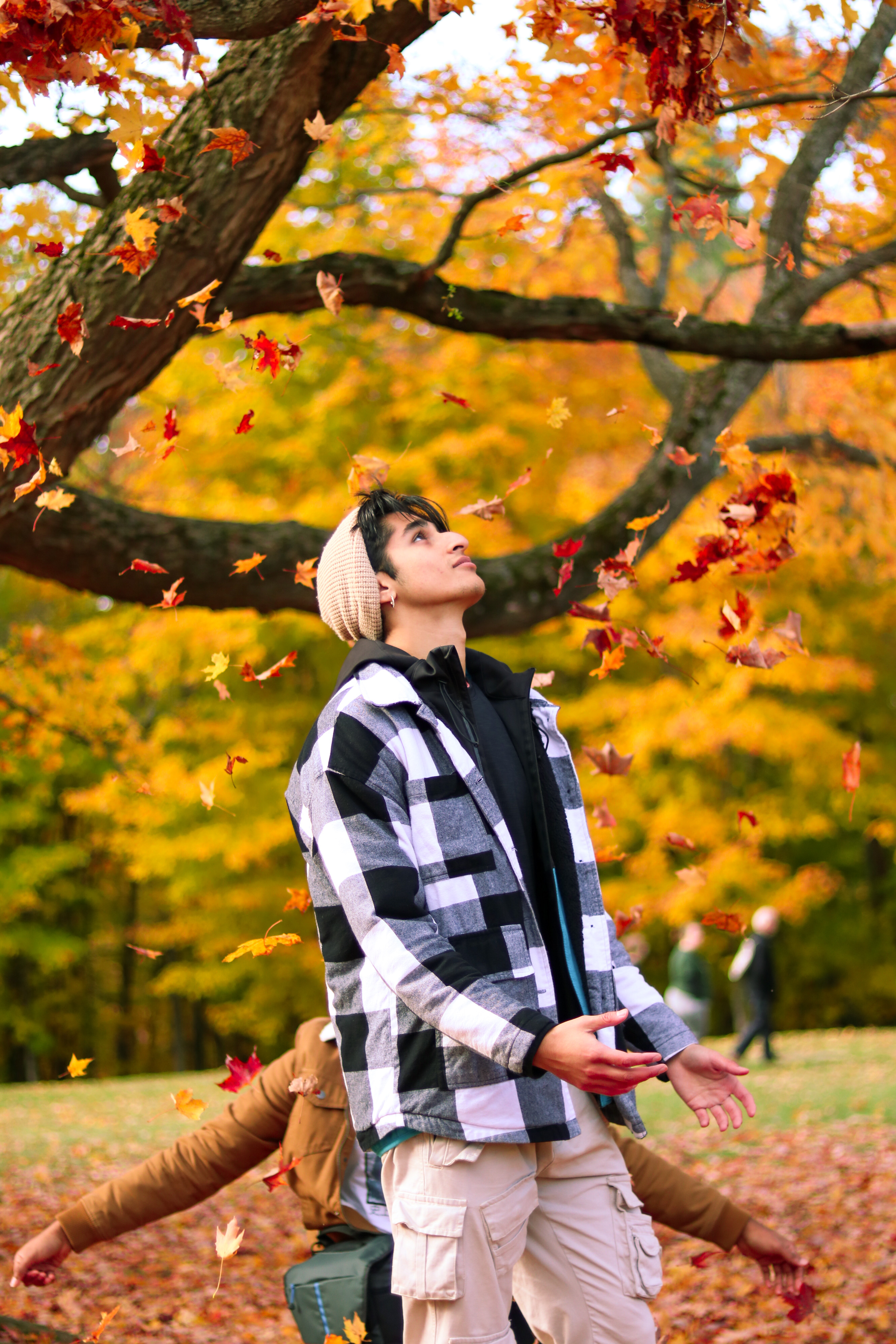 A candid photo of a girl posed in a forest, holding her camera